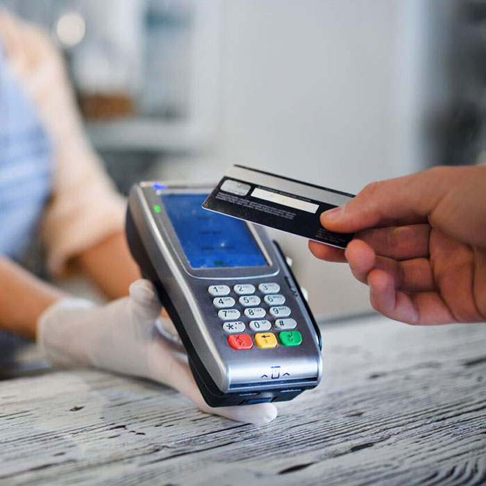 person swiping a debit card