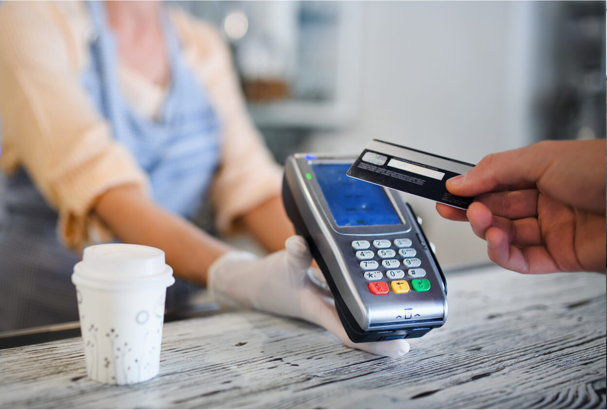 person swiping a debit card